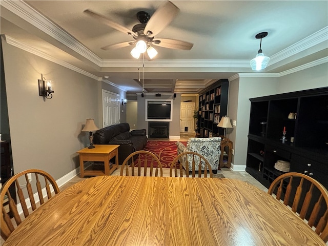 dining space featuring ceiling fan and crown molding