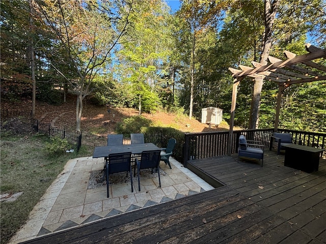 deck featuring a patio, a storage shed, and a pergola