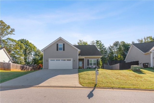 traditional-style house featuring a garage, concrete driveway, a front yard, and fence