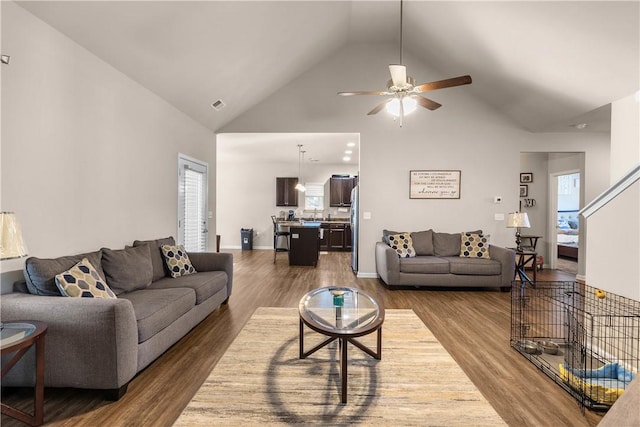 living room with high vaulted ceiling, dark wood-type flooring, and ceiling fan