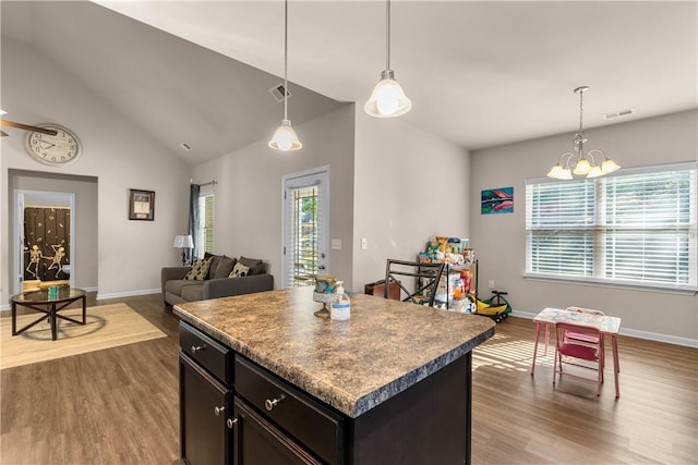 kitchen featuring pendant lighting, plenty of natural light, a center island, and hardwood / wood-style floors