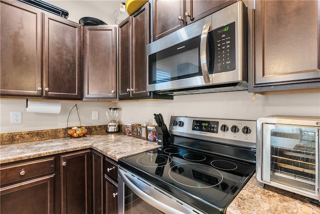 kitchen with stainless steel appliances and dark brown cabinets