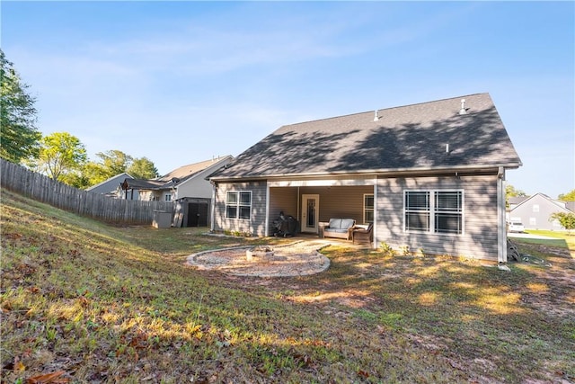 rear view of house with a yard, a patio area, and outdoor lounge area