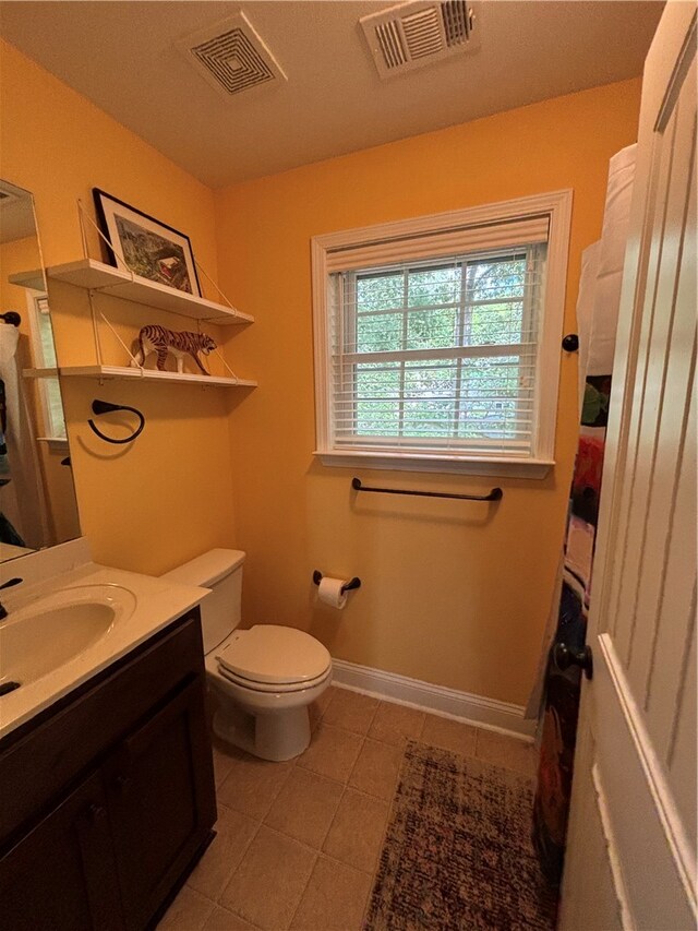 bathroom featuring toilet, vanity, and tile walls