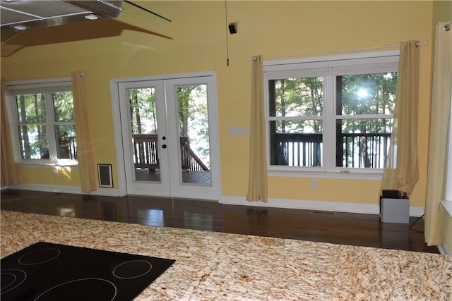 doorway with french doors and dark wood-type flooring