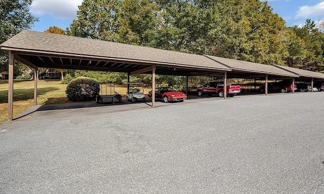 view of parking / parking lot featuring a carport