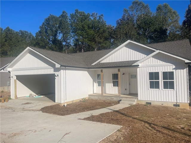 view of front of home featuring a porch and a garage