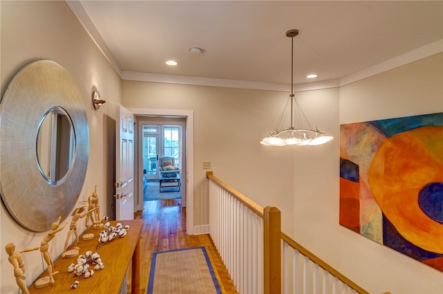 corridor with ornamental molding, hardwood / wood-style floors, and french doors