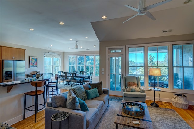 living room with light wood-type flooring and ceiling fan