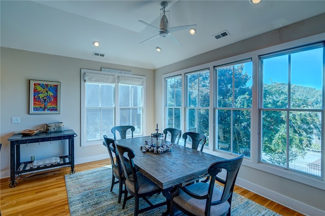 dining space with light hardwood / wood-style flooring, ceiling fan, and plenty of natural light