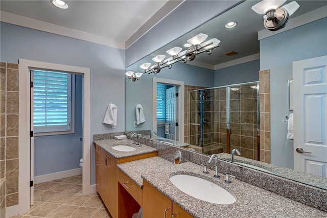 bathroom featuring vanity, toilet, tile patterned flooring, and a shower with door