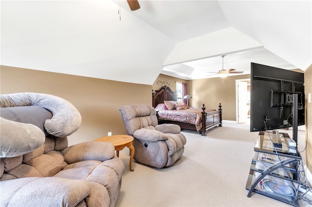 carpeted bedroom with ceiling fan and vaulted ceiling