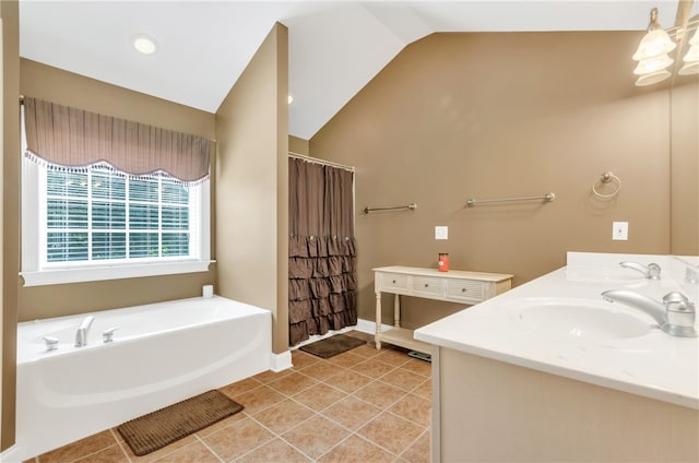 bathroom with tile patterned flooring, vanity, a bathing tub, and lofted ceiling