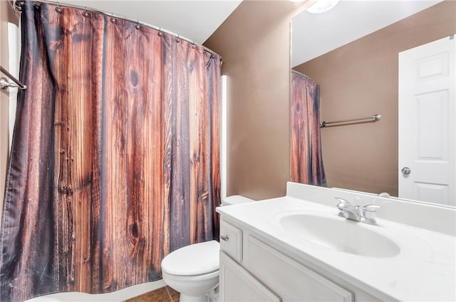 bathroom with tile patterned flooring, vanity, and toilet