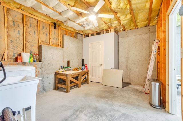 basement featuring ceiling fan and sink