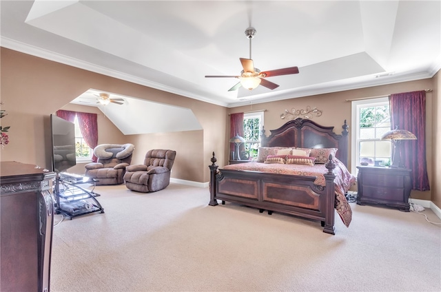 bedroom with a raised ceiling, ceiling fan, light colored carpet, and crown molding