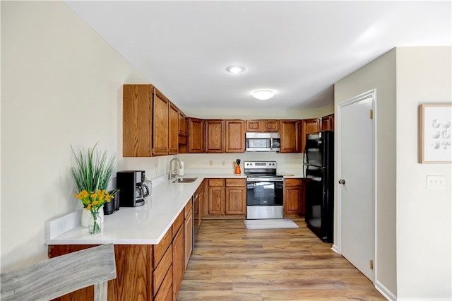 kitchen featuring light hardwood / wood-style flooring, stainless steel appliances, and sink