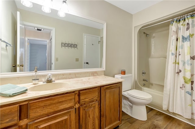 full bathroom featuring vanity, shower / bath combination with curtain, hardwood / wood-style flooring, and toilet