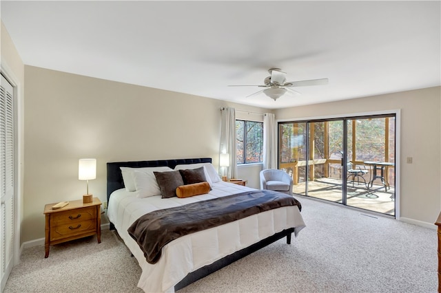 bedroom featuring a closet, ceiling fan, light colored carpet, and access to exterior