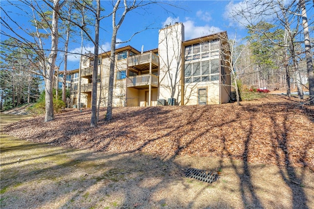 rear view of property featuring a balcony