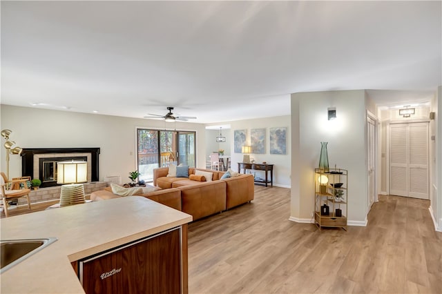 living room featuring light hardwood / wood-style floors and ceiling fan