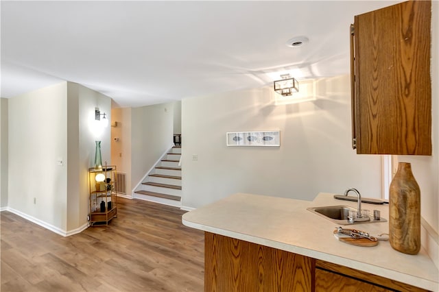 bar featuring hardwood / wood-style flooring and sink