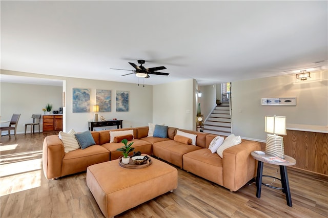 living room featuring light hardwood / wood-style flooring and ceiling fan