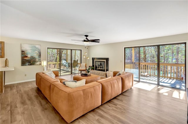 126 E Blue Heron Dr, Salem, SC 29676 - living room featuring light wood finished floors, baseboards, ceiling fan, and a tile fireplace