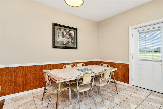 tiled dining area with wooden walls