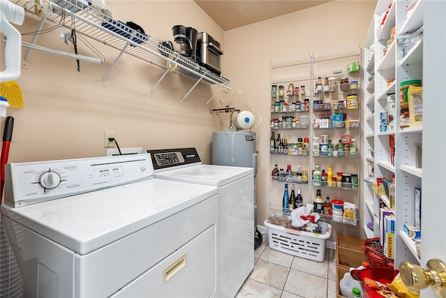 clothes washing area with water heater, light tile patterned floors, and separate washer and dryer