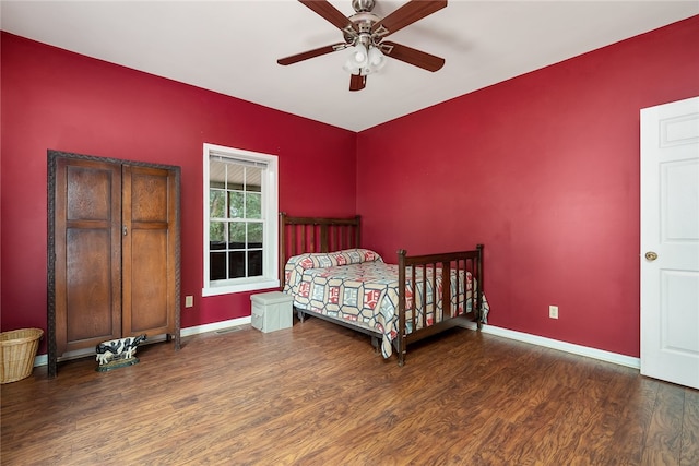 bedroom featuring ceiling fan and dark hardwood / wood-style floors