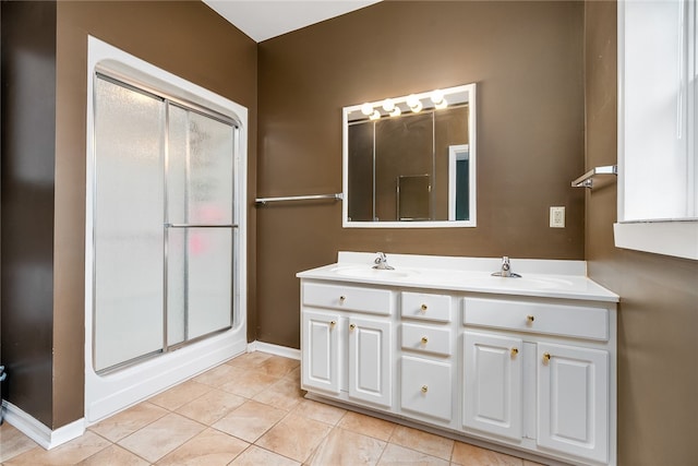 bathroom featuring tile patterned floors, vanity, and an enclosed shower