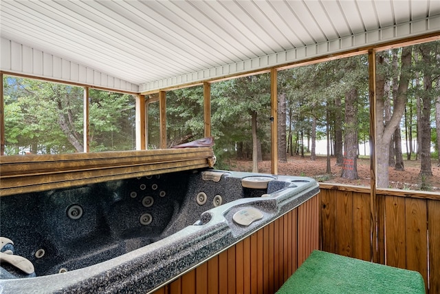 sunroom / solarium featuring vaulted ceiling, wood ceiling, and a hot tub