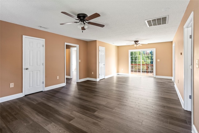 empty room with a textured ceiling, ceiling fan, and dark wood-type flooring