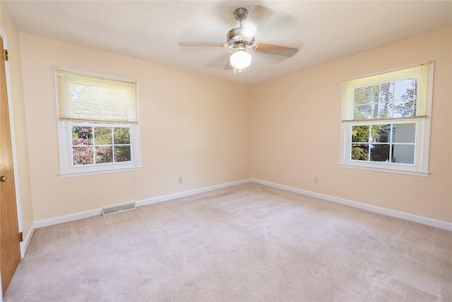 spare room featuring ceiling fan and light colored carpet