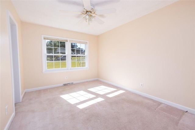 carpeted spare room with ceiling fan