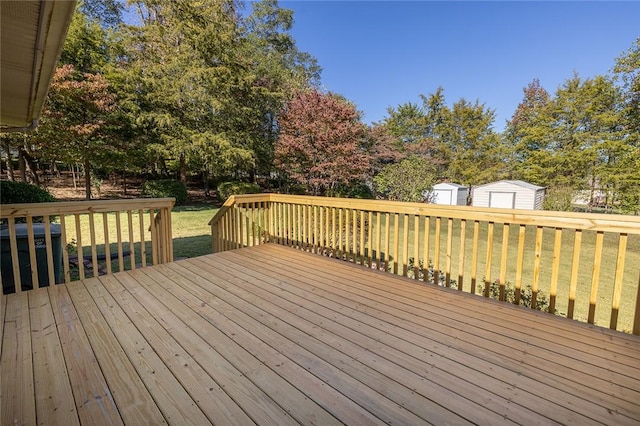 wooden deck with a yard and a shed