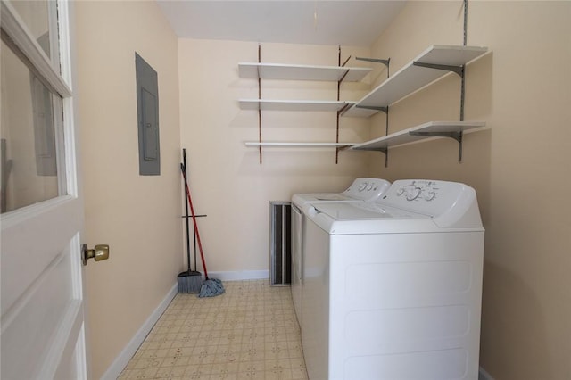 clothes washing area featuring electric panel and washer and clothes dryer