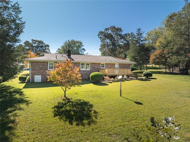 back of house featuring a yard and a wooden deck