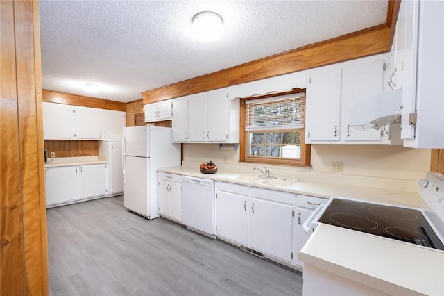 kitchen featuring white appliances, white cabinetry, sink, and a textured ceiling