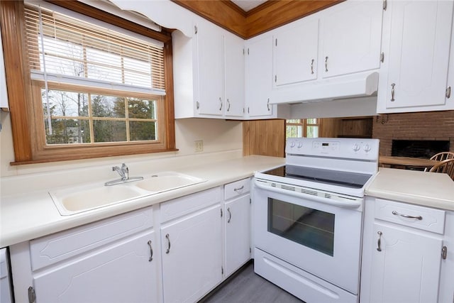 kitchen featuring sink, white appliances, and white cabinetry