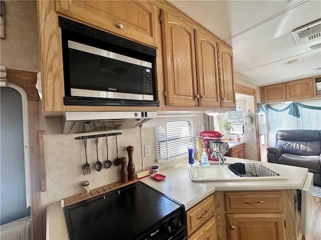 kitchen featuring black electric range oven and stainless steel microwave