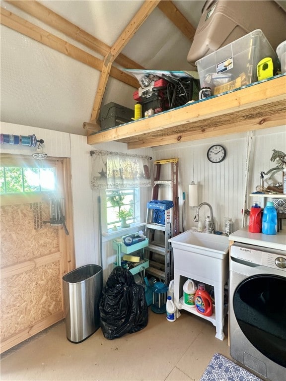 washroom featuring plenty of natural light, sink, and washer / clothes dryer