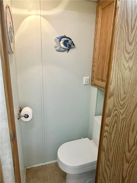 bathroom featuring toilet and tile patterned floors