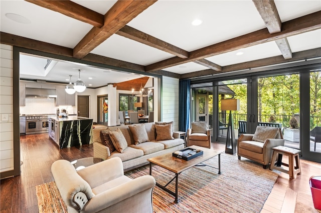 living room featuring coffered ceiling, french doors, beamed ceiling, a chandelier, and dark hardwood / wood-style flooring