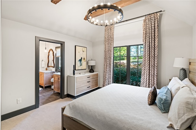 carpeted bedroom featuring connected bathroom, lofted ceiling, and a chandelier