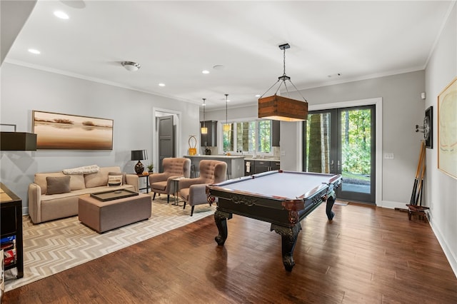 game room with light hardwood / wood-style floors, ornamental molding, and billiards