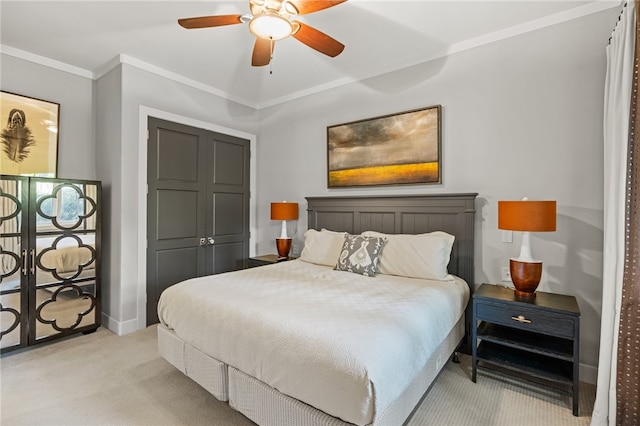 carpeted bedroom with ornamental molding and ceiling fan