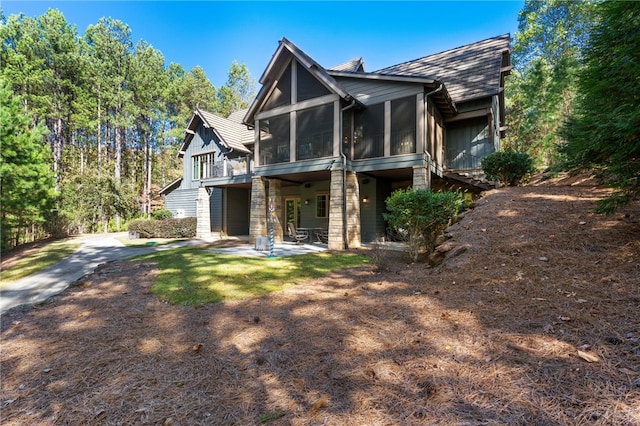 back of house featuring a patio and a sunroom