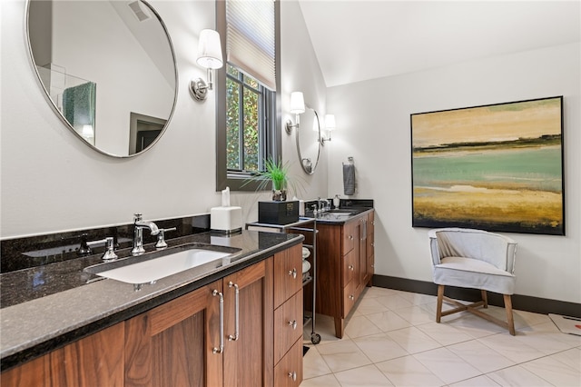 bathroom featuring vanity, tile patterned floors, and vaulted ceiling